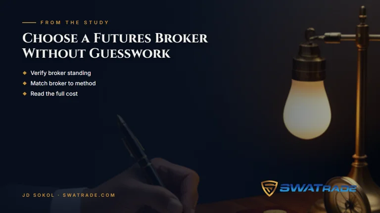 Hand writing on paper beside a lamp | How to Choose a Futures Broker Without Guesswork